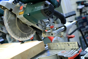 Circular saw with a wooden beam and measuring scale