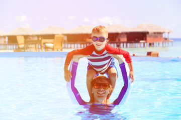 father and son having fun in swimming pool