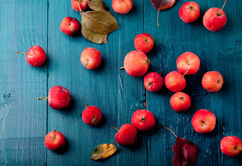Red apples and leaves Wooden blue, turquoise background