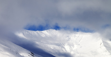 Panoramic view on off-piste slope in mist