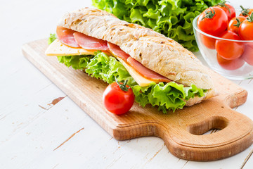 Sandwich with cheese abd ham, salad and tomatoes