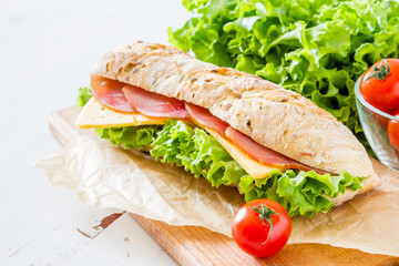 Sandwich with cheese abd ham, salad and tomatoes