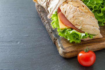 Sandwich with cheese abd ham, salad and tomatoes