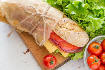 Sandwich with cheese abd ham, salad and tomatoes