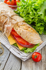 Sandwich with cheese abd ham, salad and tomatoes