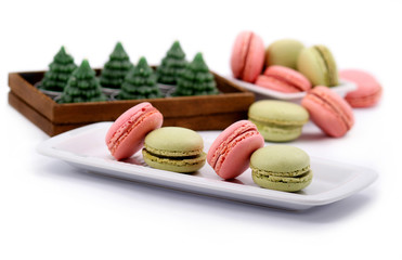 Pink and green macaron on a white plate