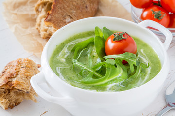 Arugula and tomatoes puree soup in white bowl