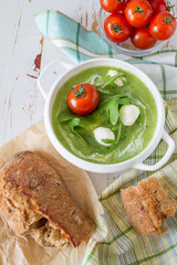Arugula and tomatoes puree soup in white bowl