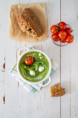 Arugula and tomatoes puree soup in white bowl
