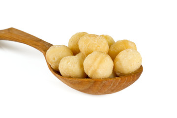 salted macadamia nuts isolated on white