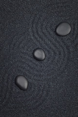 Zen garden with white marble rocks and wave pattern in the black