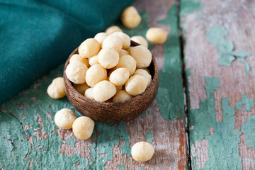 salted macadamia nuts on wooden surface
