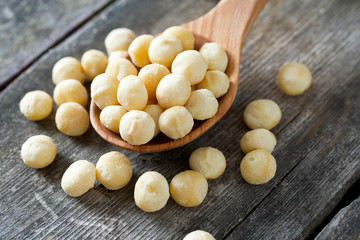 salted macadamia nuts on wooden surface