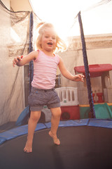Toddler jumping on a trampoline