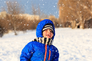 Fototapeta na wymiar little boy enjoy snow in winter nature
