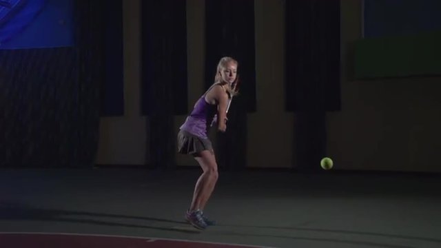 Tennis shots: Backhand (slow motion). Attractive girl playing tennis. Professional tennis player