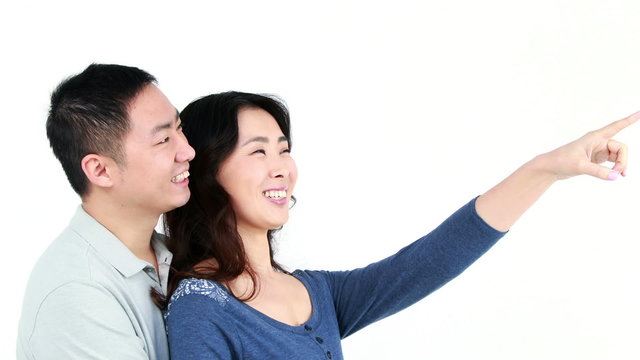 Happy couple pointing something
