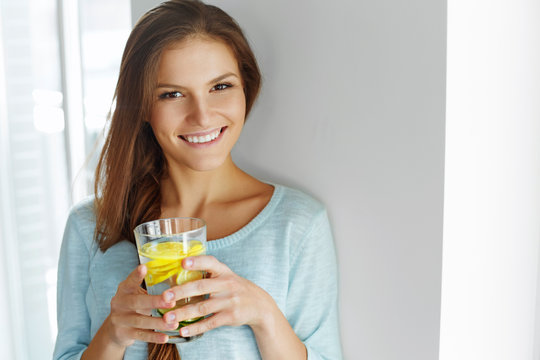 Healthy Lifestyle And Food. Woman Drinking Fruit Water. Detox. 