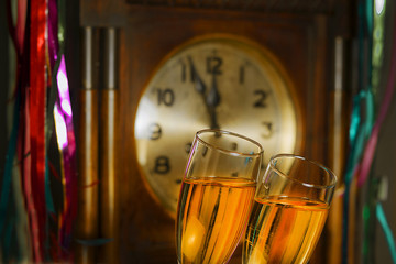 Glasses of champagne on the background of the old clock © GieZetStudio