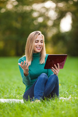 Young woman is chatting with her friend in park