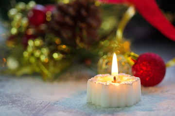 Burning candle with christmas decoration