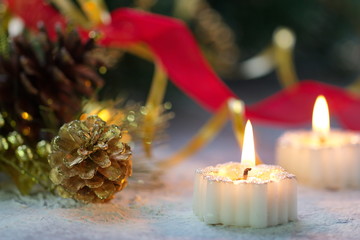 Burning candle with christmas decoration