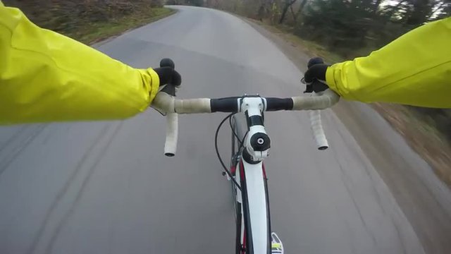 4K POV Road cycler speeding on the country road in fall
