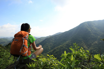 Fototapeta na wymiar young woman enjoy the view at mountain peak 