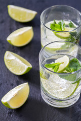 Fototapeta premium Mojito and ingredients, dark stone background