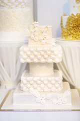 Wedding cake decorated with white lace and flowers