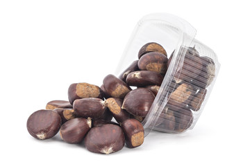 Box or punnet and spilled fresh organic chestnuts isolated on white background