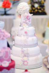White wedding cake decorated with sugar flowers