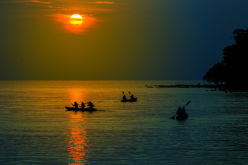 Tourists kayaking on tropical island