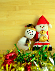 Santa claus and snowman on wood background