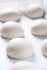 Pizza ball dough on white tray 