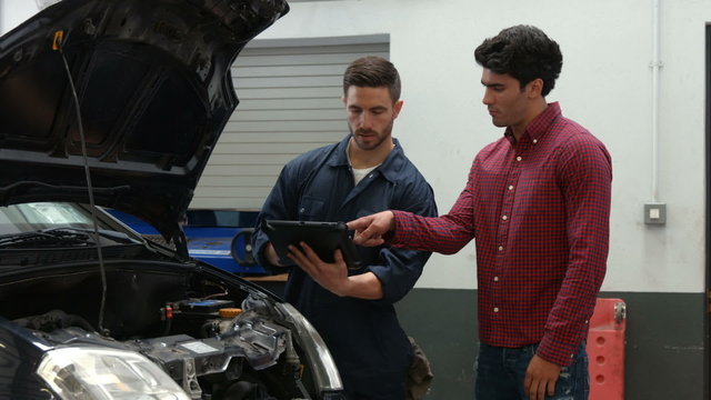 Mechanics overhauling an engine