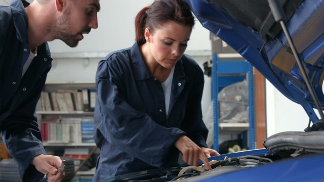 Mechanics repairing an engine