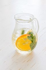 Lemonade and ingredients on white wood background