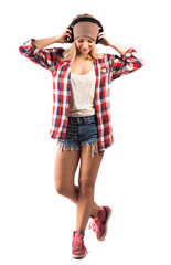 Young hipster woman posing in studio with white background