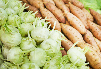 fresh green kohlrabi cabbage and yam on market