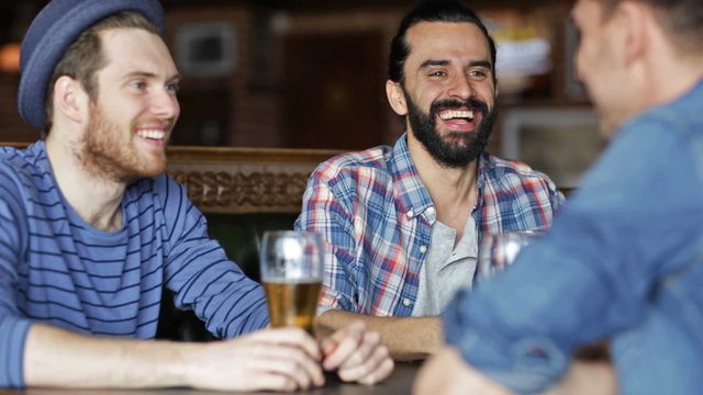 happy male friends drinking beer at bar or pub