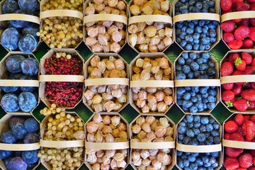Colorful mixed berries in containers at the farmers market