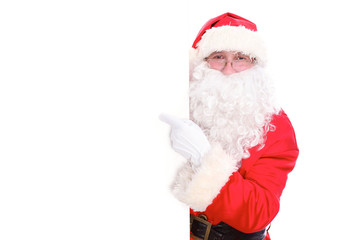 Fototapeta na wymiar Kind Santa Claus pointing in white blank sign, isolated on white background
