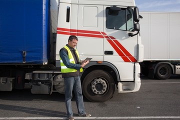 confident Man standing in front of truck