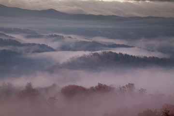 red-hued morning fog over smoky mountains