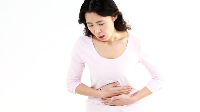 Pretty Asian woman with stomach ache