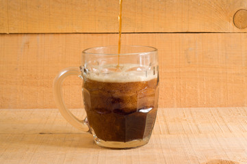 Beer dark on wooden background