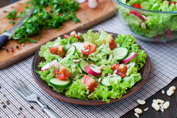 Tomato and cucumber salad with lettuce leafes