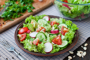 Tomato and cucumber salad with lettuce leafes