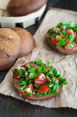 Italian tomato bruschetta with chopped vegetables, herbs and oil
